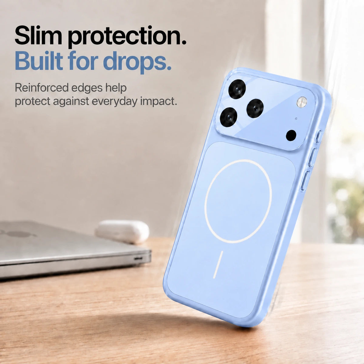 Glacier slim phone case leaning on one corner on a wooden desk, showing reinforced edges #color_Glacier