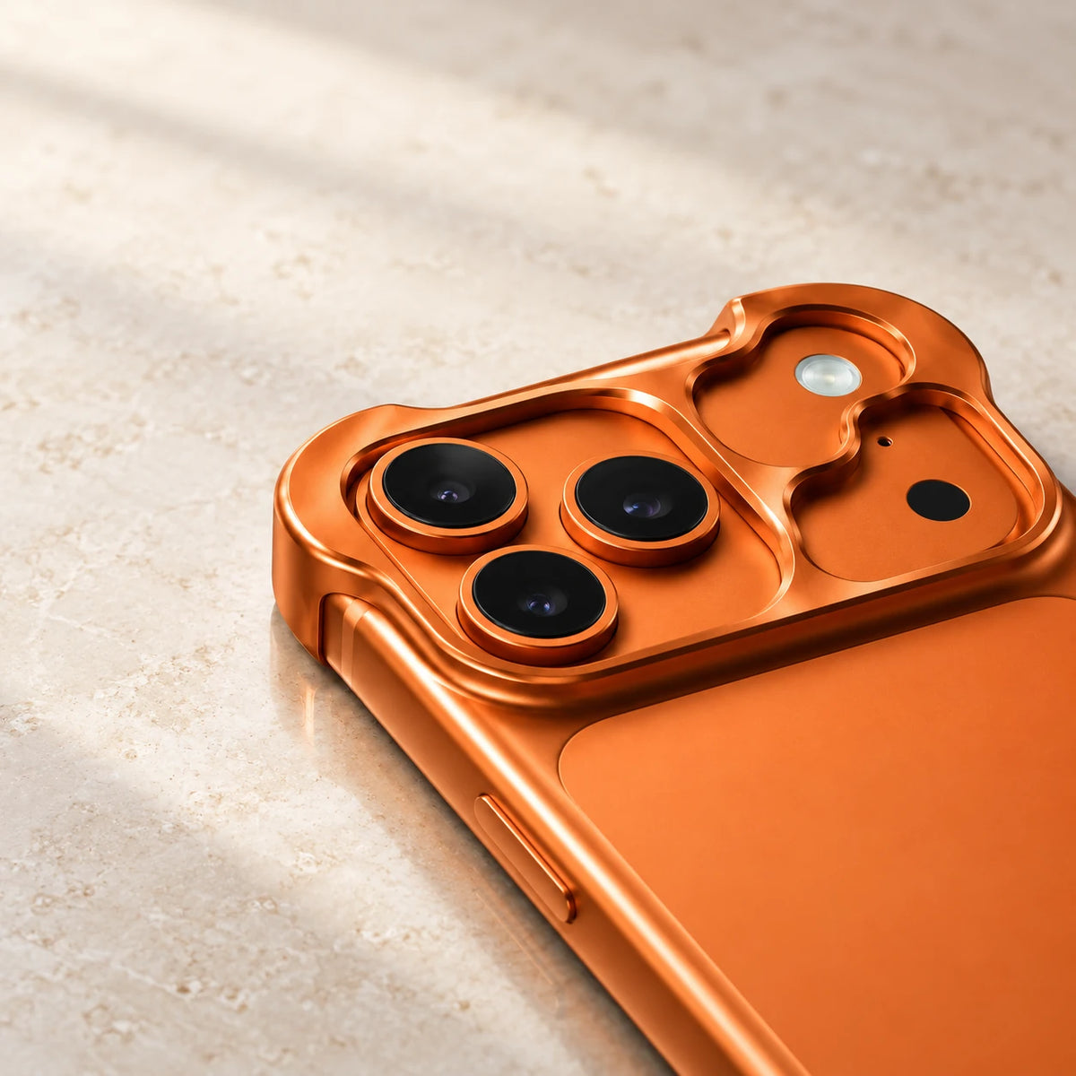 Close-up of the sculpted orange metal guard around three rear camera lenses.
