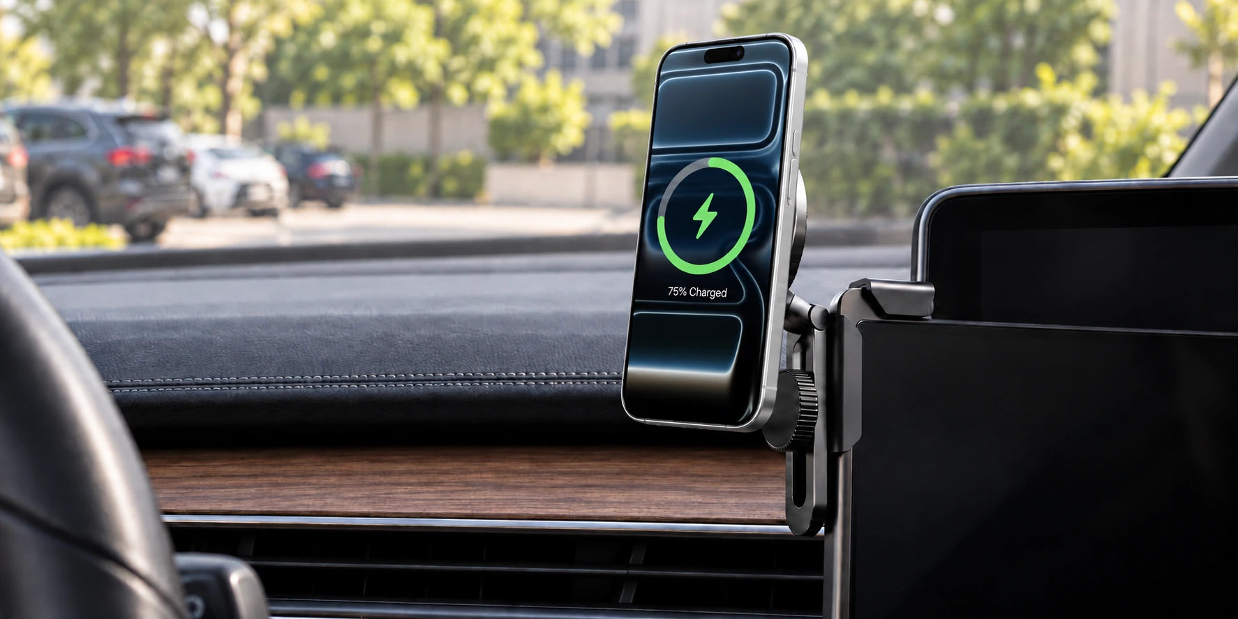 Phone mounted beside a car's center display on an adjustable screen-edge bracket.