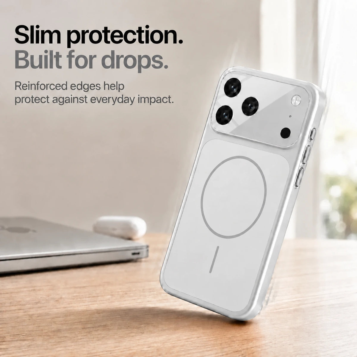 Silver slim phone case leaning on one corner on a wooden desk, showing reinforced edges #color_Titanium Silver