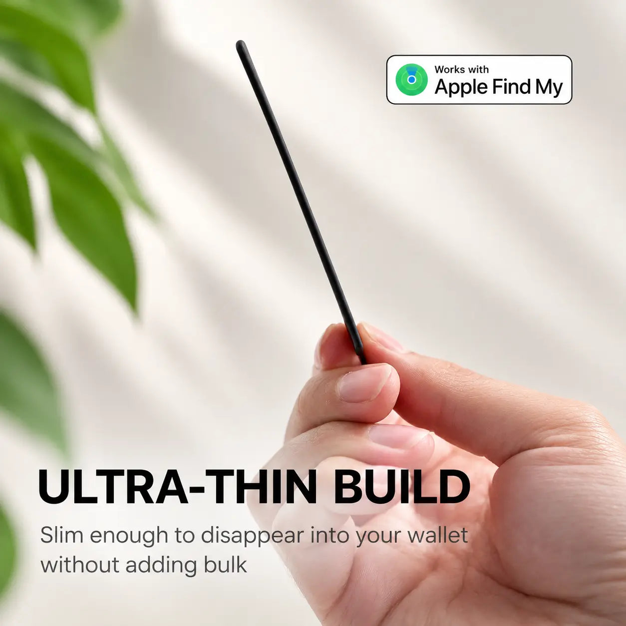 Ultra-thin AirCard tracker held edge-on between two fingers